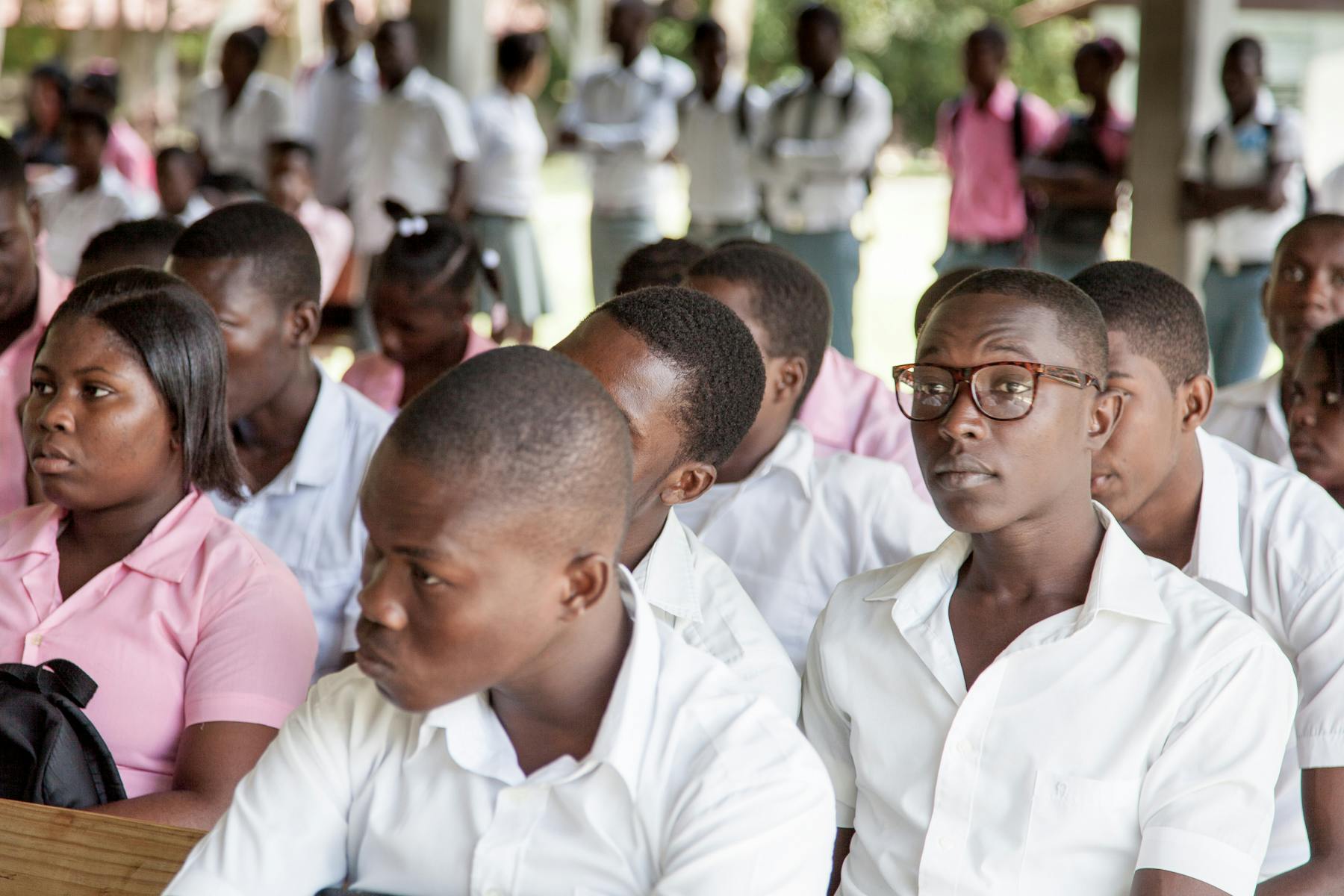 New Missions High school students listen intently during a chapel service in Signu, Haiti.